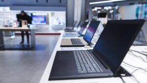 A row of laptops on display in a store